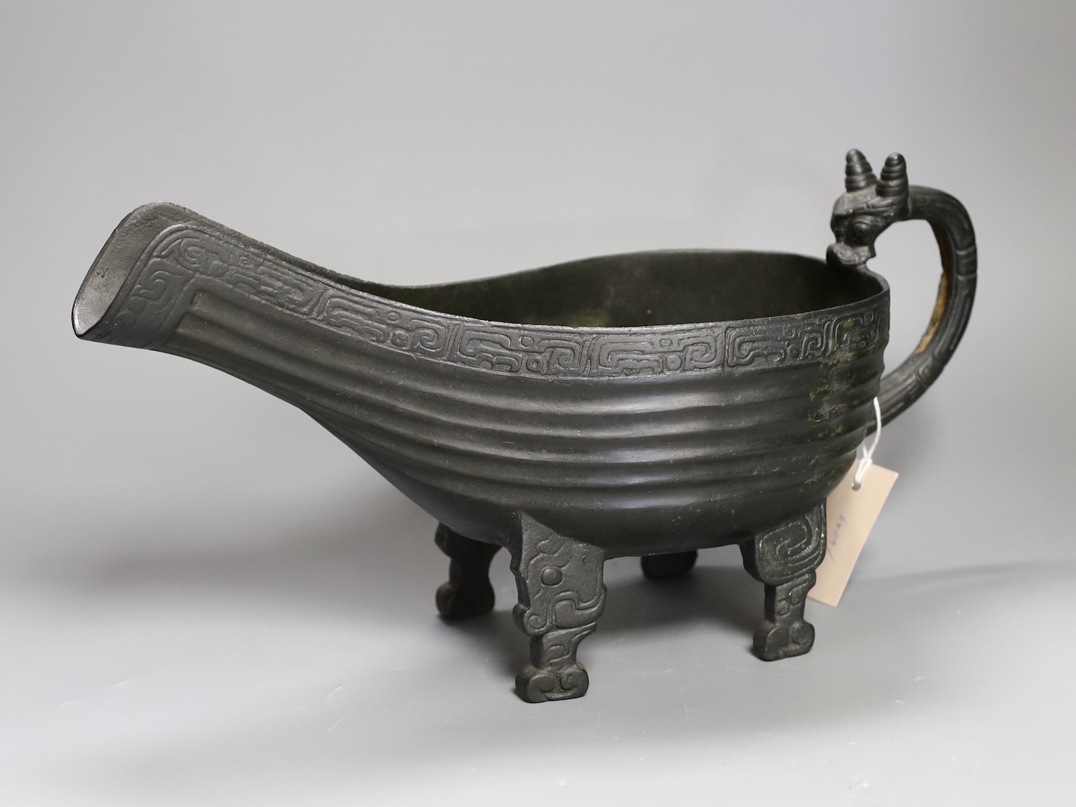 A large Chinese archaistic cast bronze pouring vessel, yi, boxed. 42cm